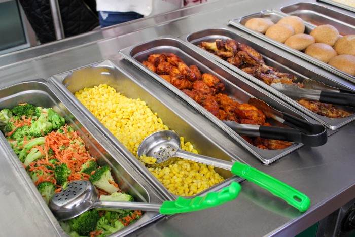 School lunch bar with broccoli and mixed vegetables, corn, and meat