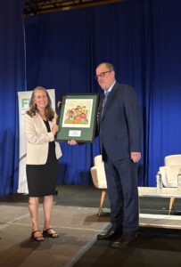 Randy Rosso receives the Raymond Wheeler/Senator Paul Wellstone Anti-Hunger Advocacy Leadership Award from FRAC President Crystal FitzSimons