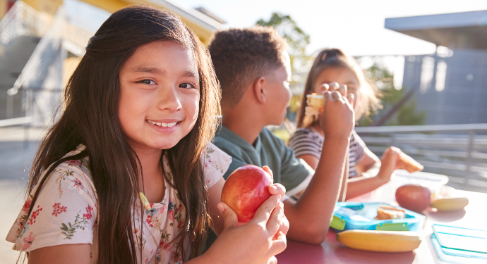 Young Students Outside Eating Lunch